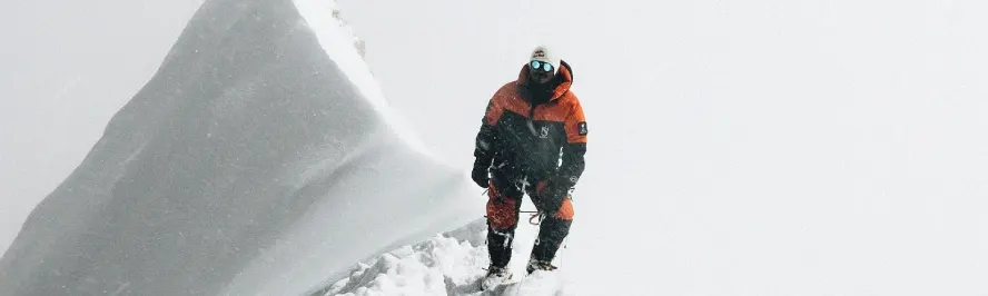 Mountaineer climbing a snowy Himalayan peak