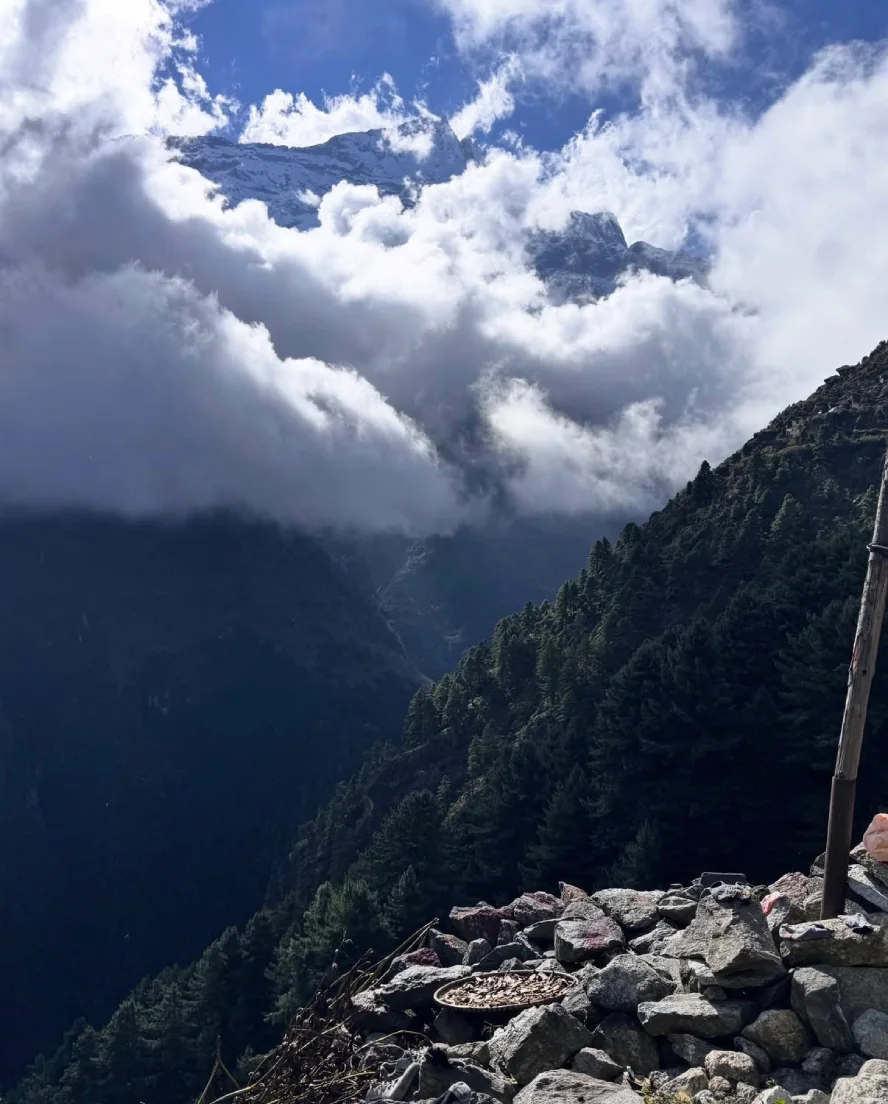 Snow-covered Himalayan peaks and clouds along the Everest Base Camp trail in April.