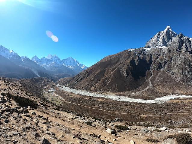 Quiet Everest region trail with mountain views in July.