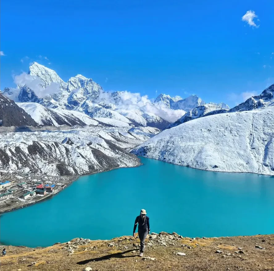 Trekker standing infront of Gokyo Lake on the Everest Base Camp route via Gokyo Lakes and Cho La Pass