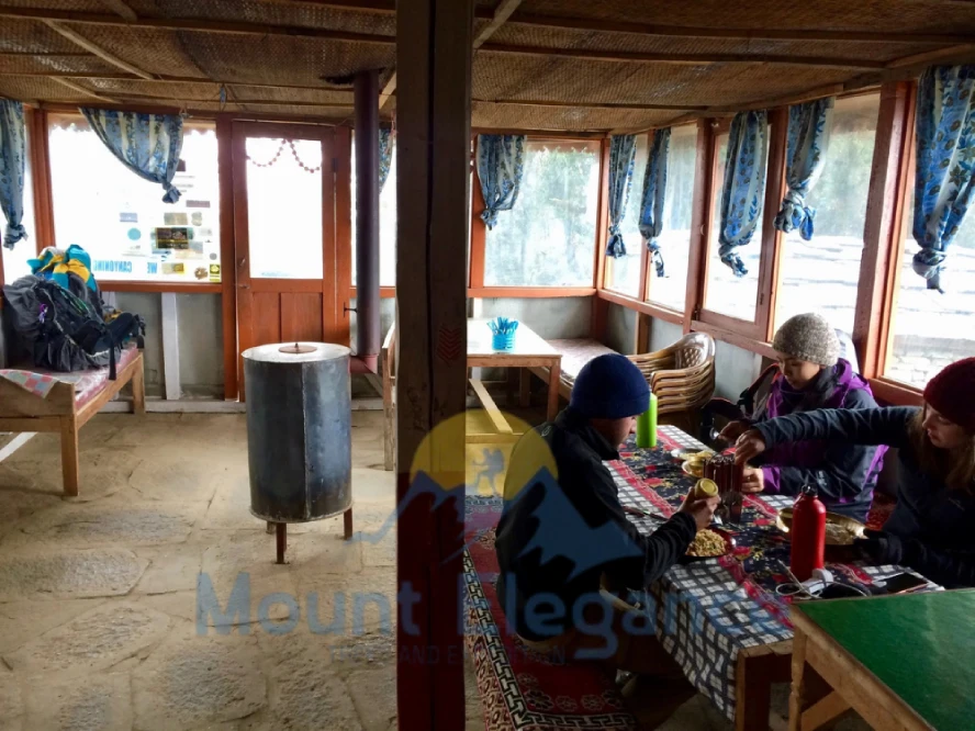 Communal dining hall in a Dingboche teahouse, heated by a stove in the evening