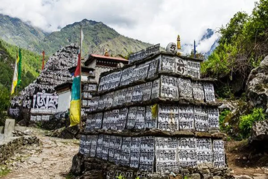 Prayer flags and carved mani stones along the trail through Dingboche village