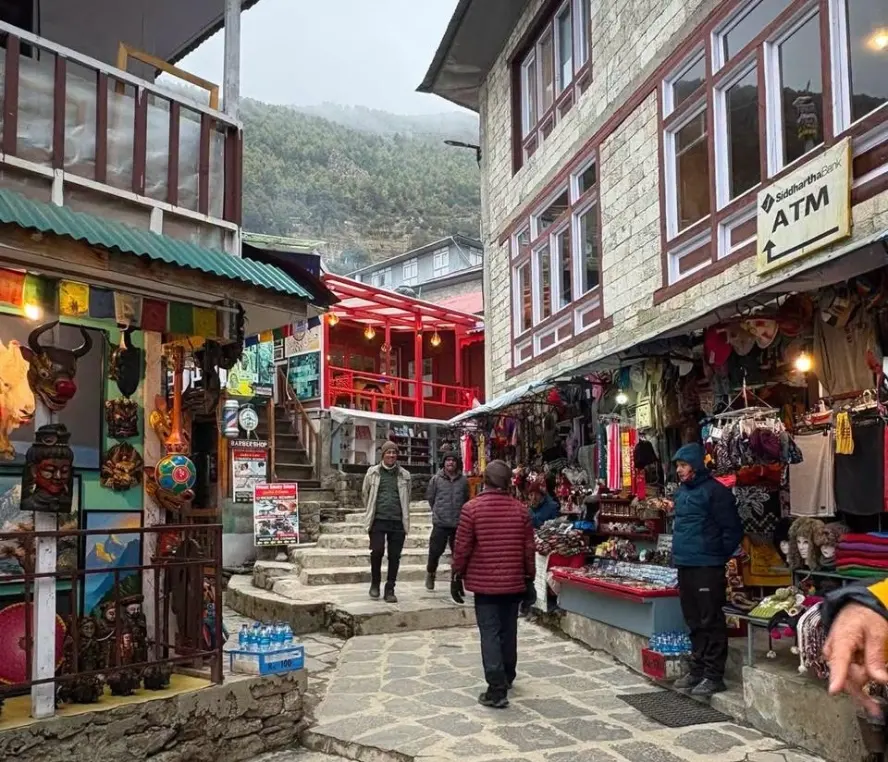 Namche Bazaar's Saturday market, with Tibetan traders selling produce, butter, and trekking gear.