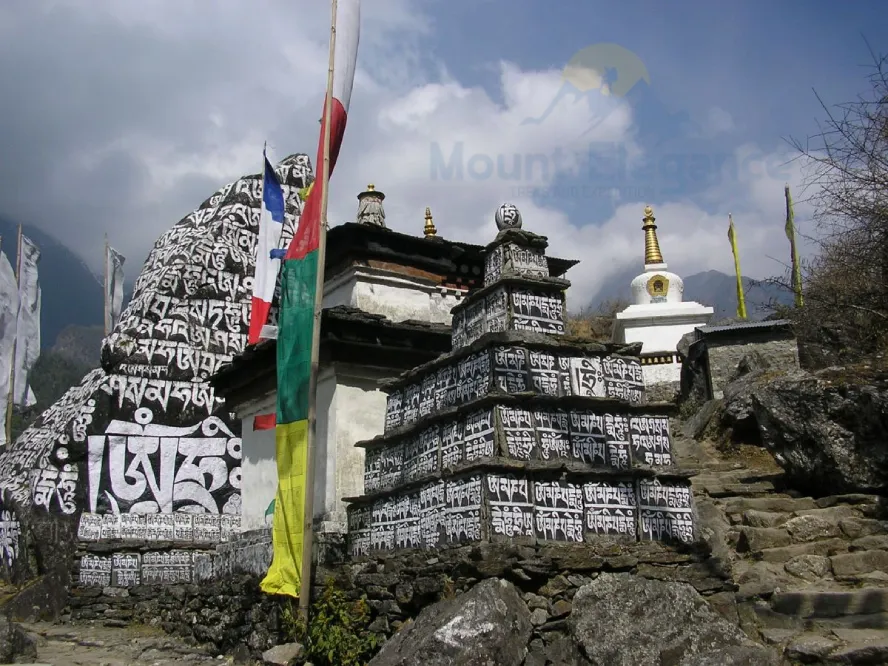 Rimishung Monastery in Phakding with prayer flags and mani stone wall