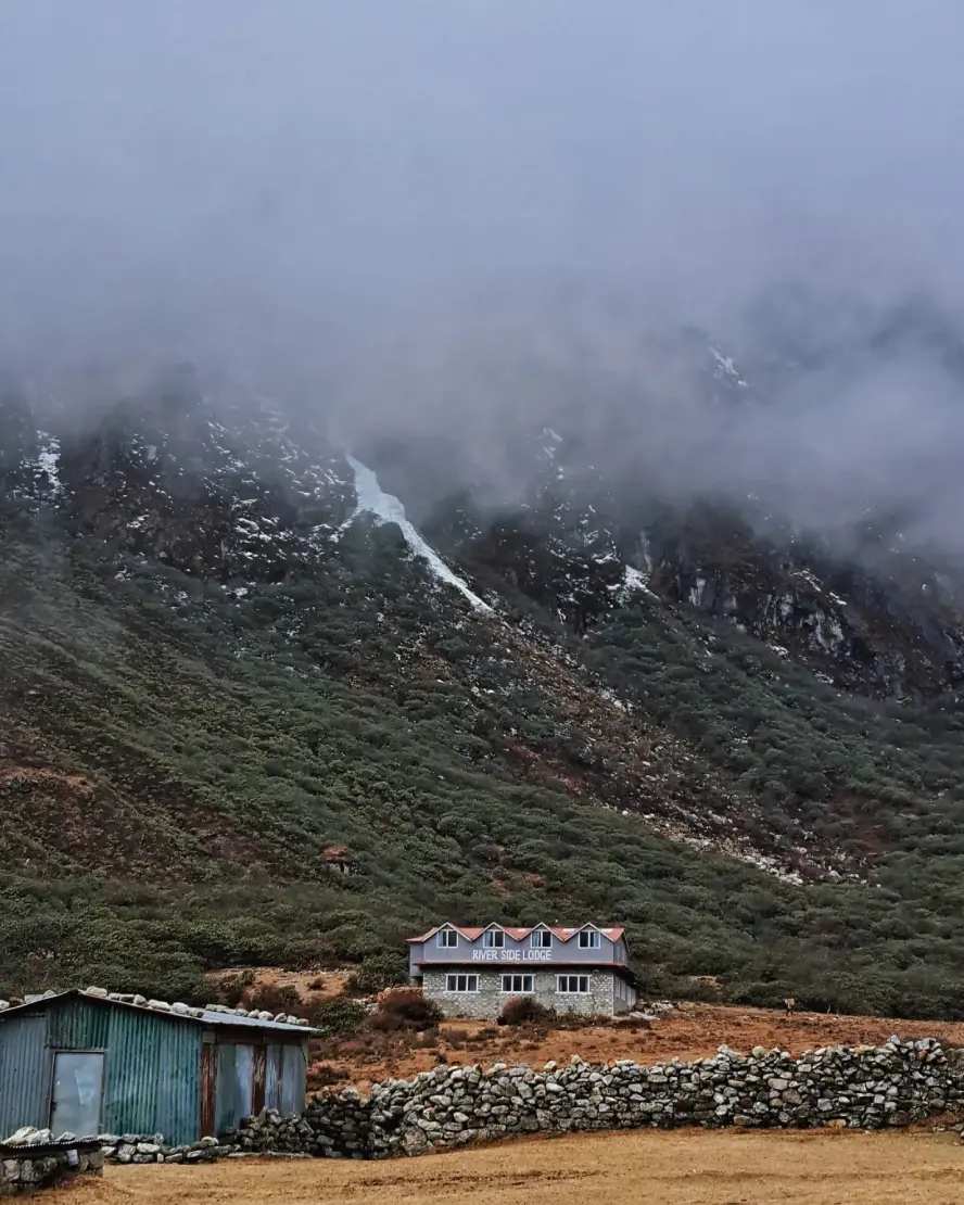 Stone lodges and homes along a village path in Phakding, Nepal