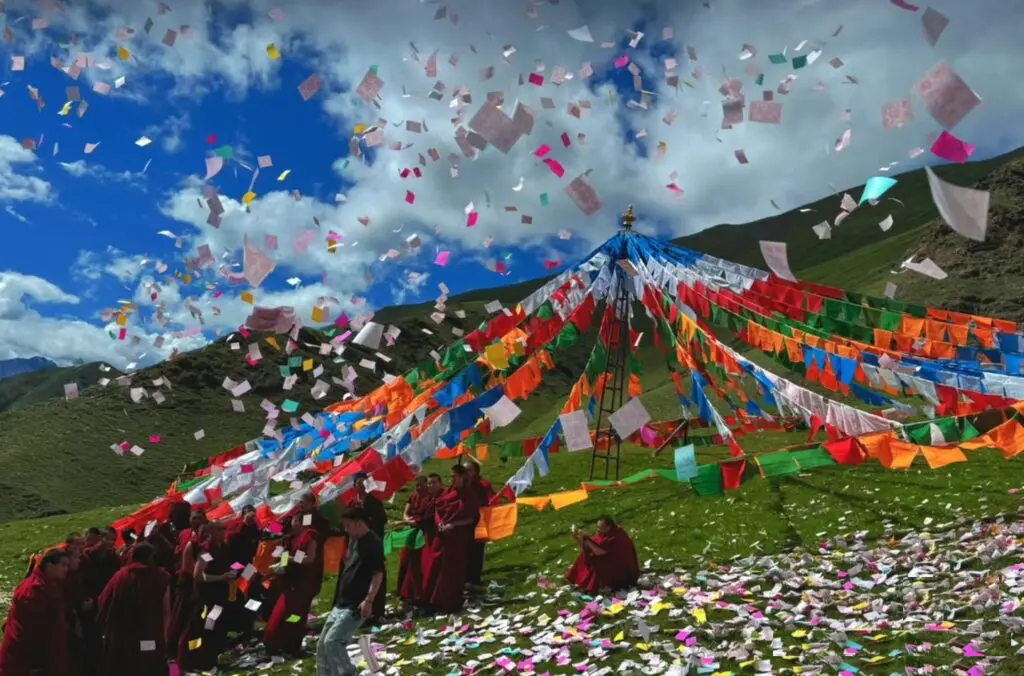 Buddhist monks and colorful prayer flags during a February festival in Nepal.